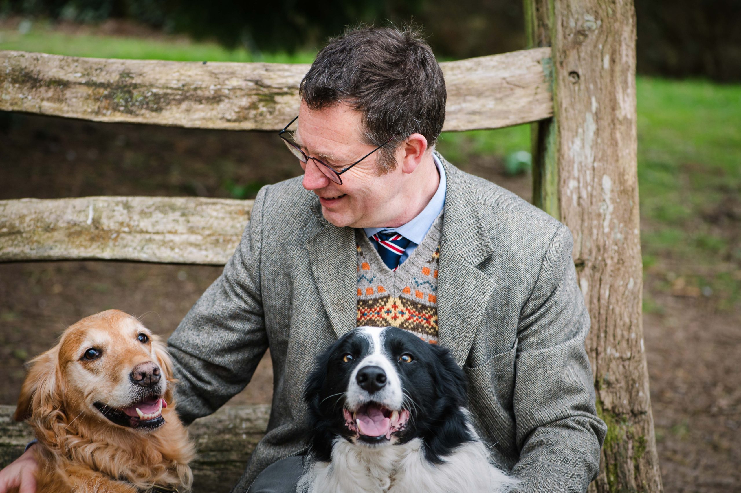Dr James Hunt outside with two happy dogs